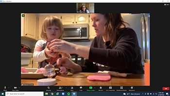 a telehealth session, the focus on a child and her mother